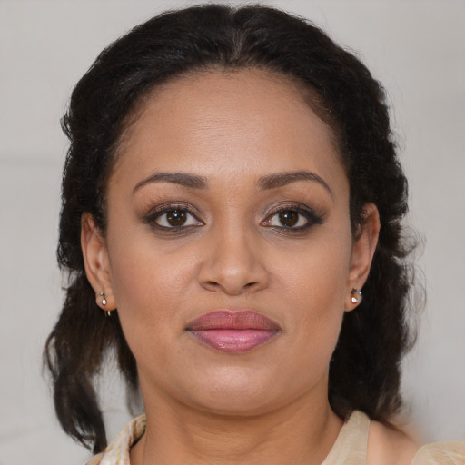 Joyful latino adult female with medium  brown hair and brown eyes