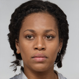 Neutral black young-adult female with medium  brown hair and brown eyes