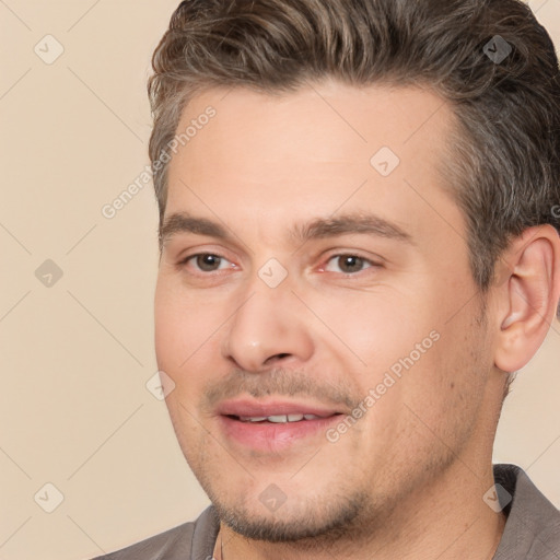 Joyful white adult male with short  brown hair and brown eyes