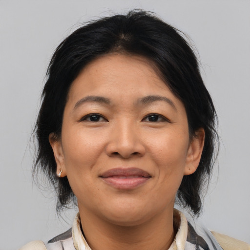 Joyful asian adult female with medium  brown hair and brown eyes