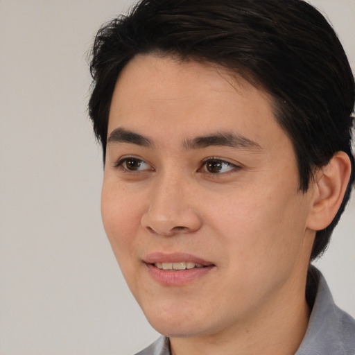 Joyful white young-adult male with short  black hair and brown eyes