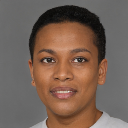 Joyful black young-adult female with short  brown hair and brown eyes