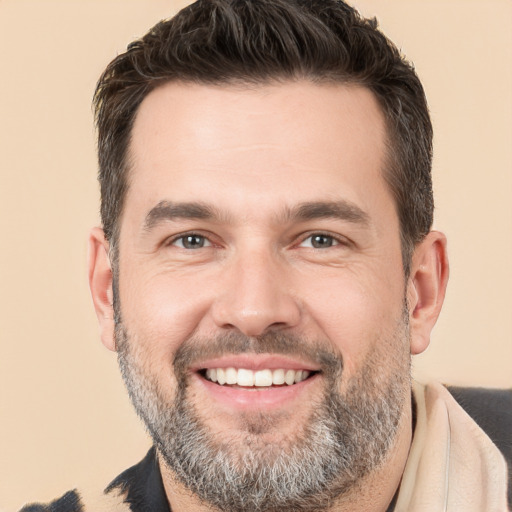 Joyful white adult male with short  brown hair and brown eyes