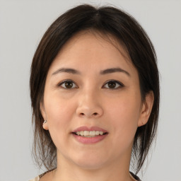 Joyful asian young-adult female with medium  brown hair and brown eyes