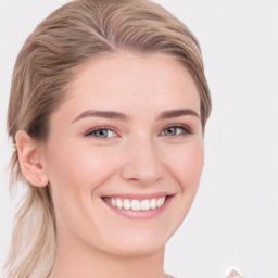 Joyful white young-adult female with long  brown hair and blue eyes