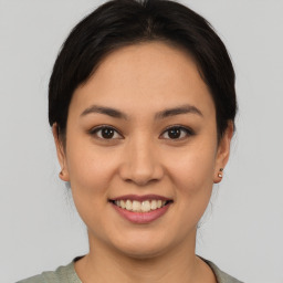 Joyful asian young-adult female with short  brown hair and brown eyes