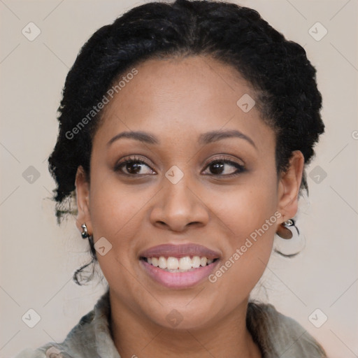 Joyful black young-adult female with long  black hair and brown eyes