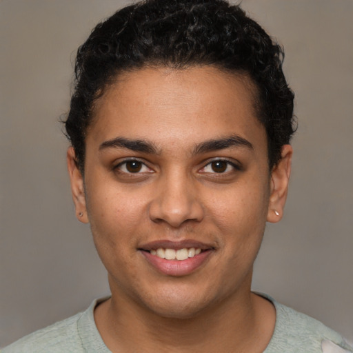 Joyful latino young-adult male with short  brown hair and brown eyes