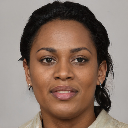 Joyful black young-adult female with medium  black hair and brown eyes