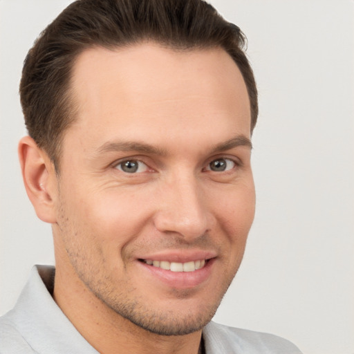 Joyful white adult male with short  brown hair and brown eyes