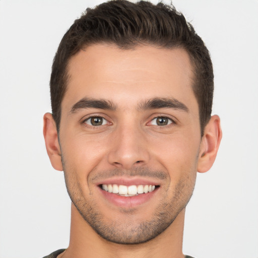 Joyful white young-adult male with short  brown hair and brown eyes