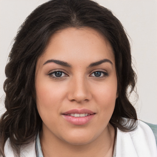 Joyful white young-adult female with long  brown hair and brown eyes