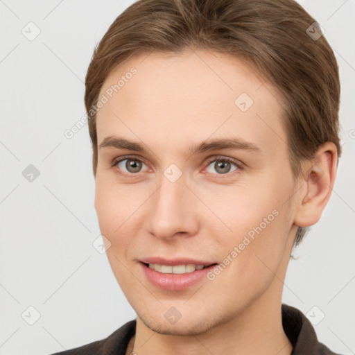 Joyful white young-adult female with short  brown hair and grey eyes