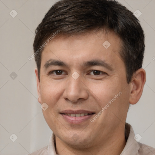 Joyful white adult male with short  brown hair and brown eyes