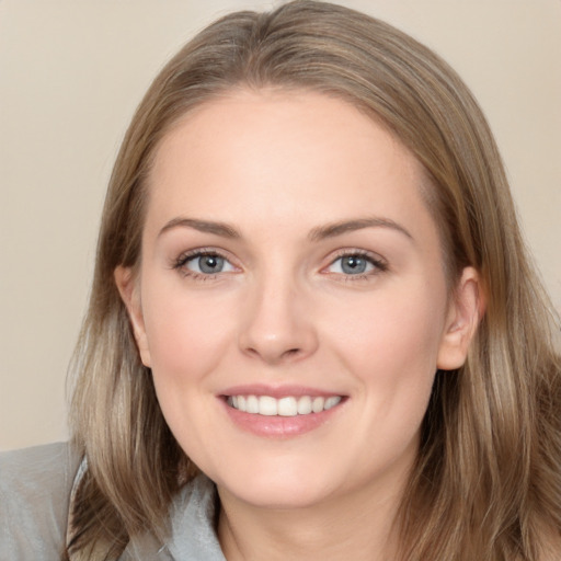 Joyful white young-adult female with long  brown hair and grey eyes