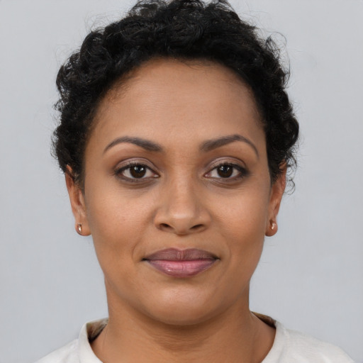 Joyful latino young-adult female with short  brown hair and brown eyes