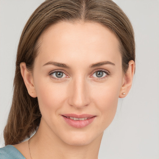 Joyful white young-adult female with medium  brown hair and blue eyes