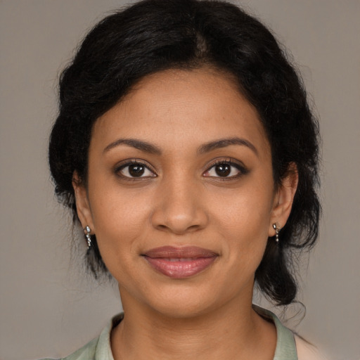 Joyful black young-adult female with medium  black hair and brown eyes