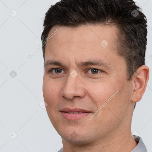 Joyful white adult male with short  brown hair and brown eyes