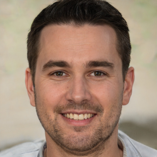 Joyful white adult male with short  brown hair and brown eyes