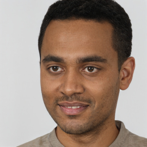 Joyful black young-adult male with short  black hair and brown eyes