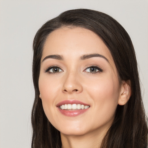 Joyful white young-adult female with long  black hair and brown eyes