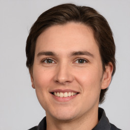 Joyful white young-adult male with medium  brown hair and brown eyes