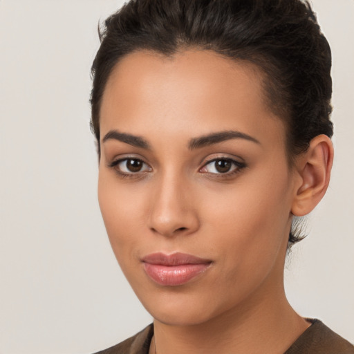 Joyful latino young-adult female with short  brown hair and brown eyes