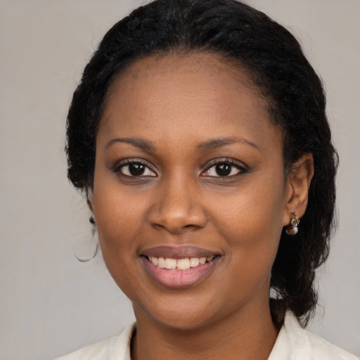 Joyful black young-adult female with medium  black hair and brown eyes
