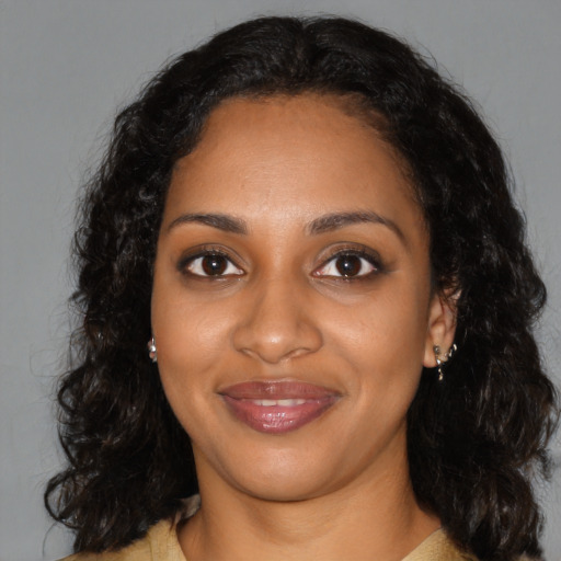 Joyful black young-adult female with medium  black hair and brown eyes