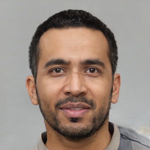Neutral latino young-adult male with short  black hair and brown eyes