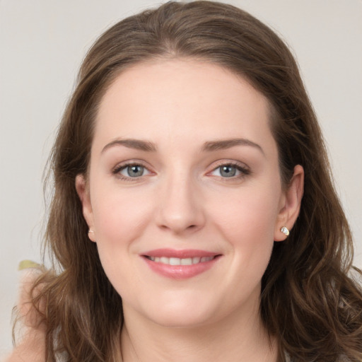 Joyful white young-adult female with long  brown hair and grey eyes