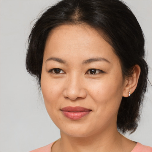 Joyful asian young-adult female with medium  brown hair and brown eyes