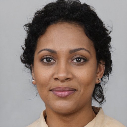 Joyful black young-adult female with medium  brown hair and brown eyes