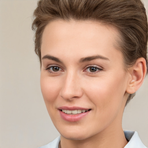 Joyful white young-adult female with short  brown hair and brown eyes