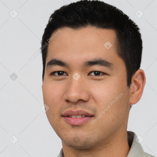 Joyful asian young-adult male with short  black hair and brown eyes