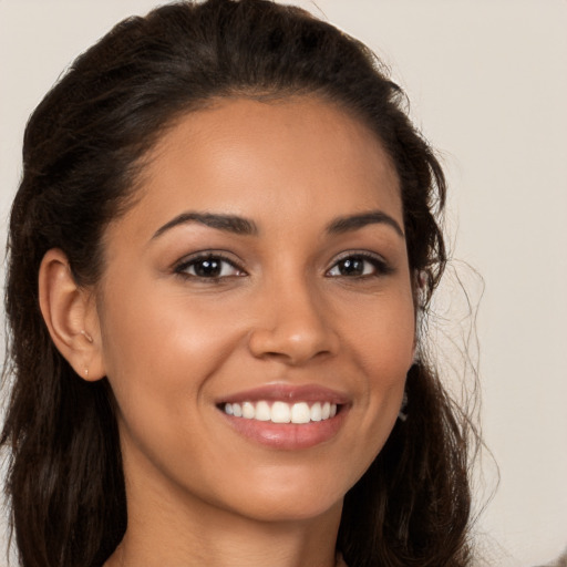 Joyful latino young-adult female with long  brown hair and brown eyes