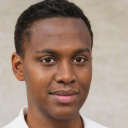 Joyful black young-adult male with short  brown hair and brown eyes