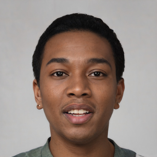 Joyful black young-adult male with short  black hair and brown eyes