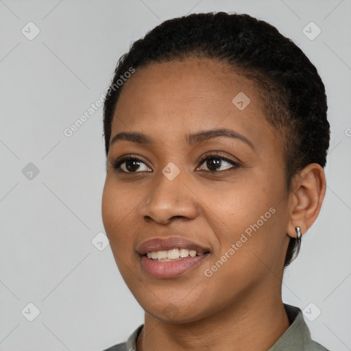 Joyful black young-adult female with short  black hair and brown eyes