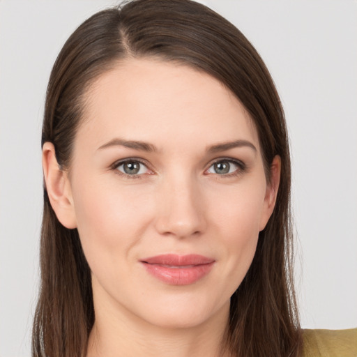 Joyful white young-adult female with long  brown hair and grey eyes