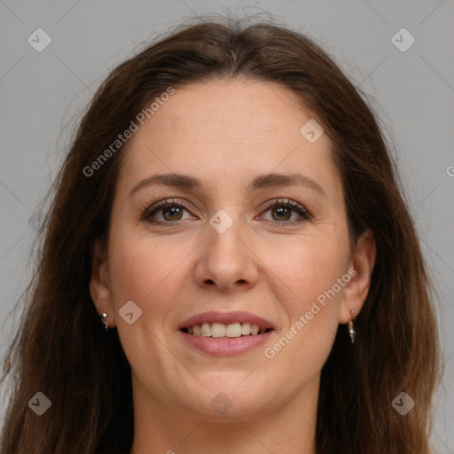 Joyful white adult female with long  brown hair and brown eyes