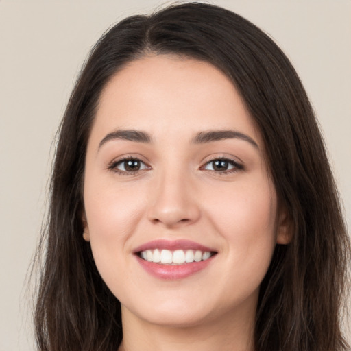 Joyful white young-adult female with long  brown hair and brown eyes