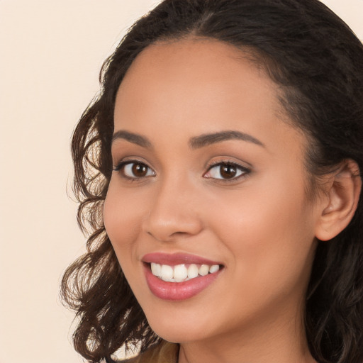 Joyful white young-adult female with long  brown hair and brown eyes