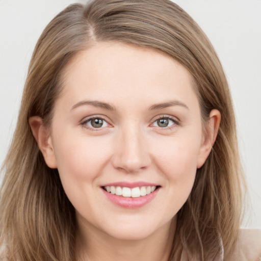 Joyful white young-adult female with long  brown hair and grey eyes