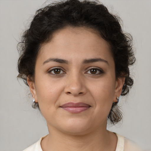 Joyful latino young-adult female with short  brown hair and brown eyes