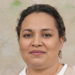 Joyful latino adult female with short  brown hair and brown eyes