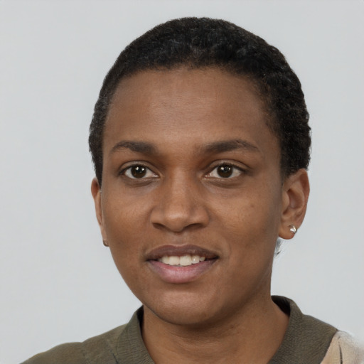 Joyful black young-adult female with short  black hair and brown eyes