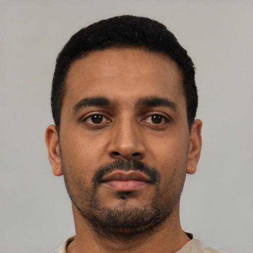 Neutral latino young-adult male with short  black hair and brown eyes