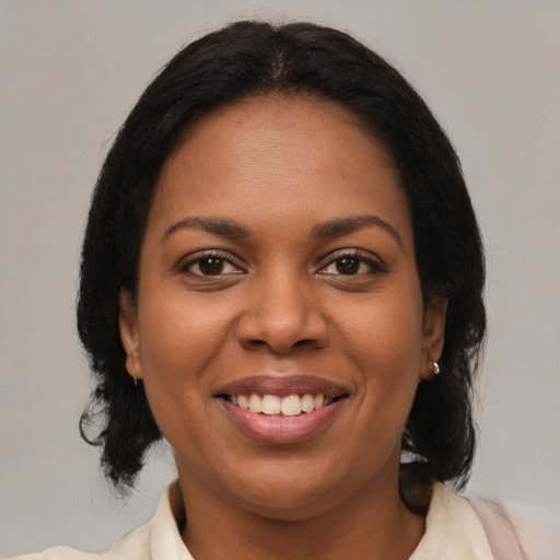 Joyful black young-adult female with medium  brown hair and brown eyes